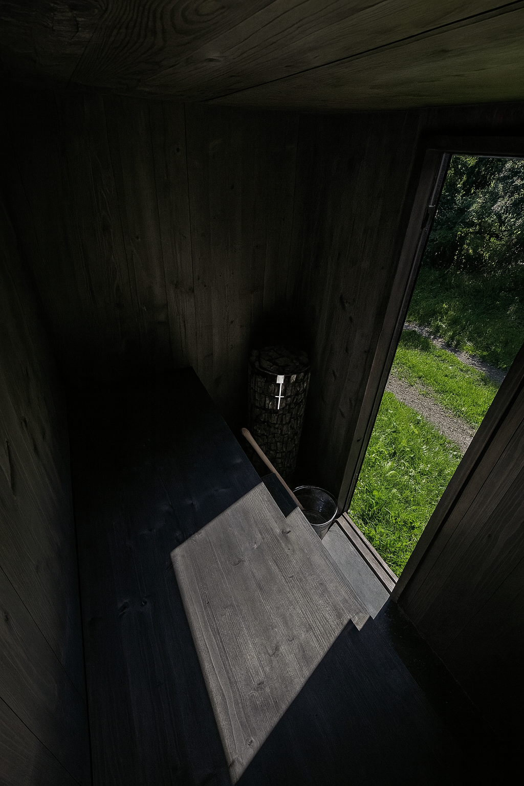 Tumma esteettinen pihasauna sisäpuolelta - Harvian sähkökiuas ja design- varustepaketti